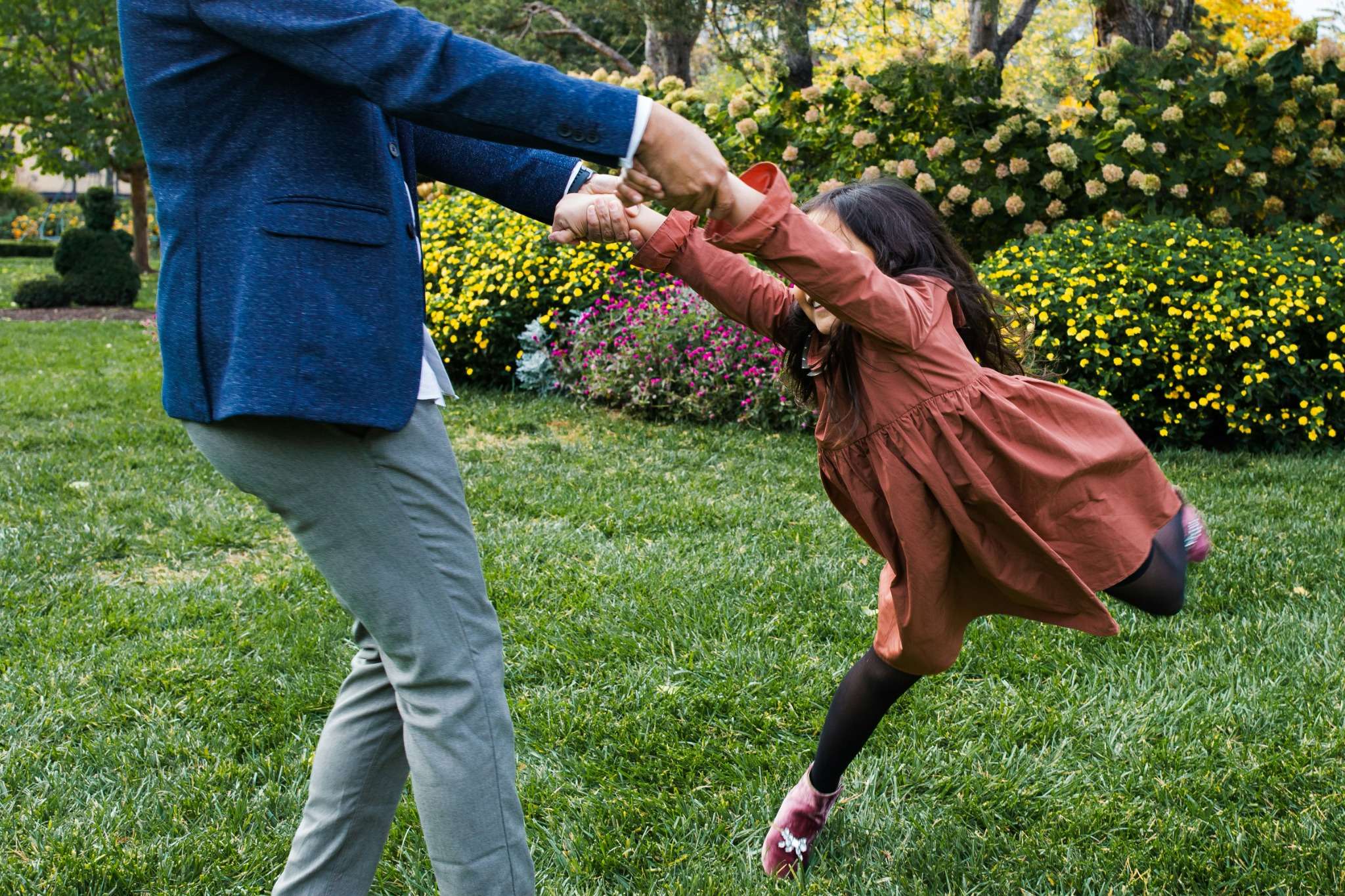 Family walking outside a tidy home with a well-kept garden